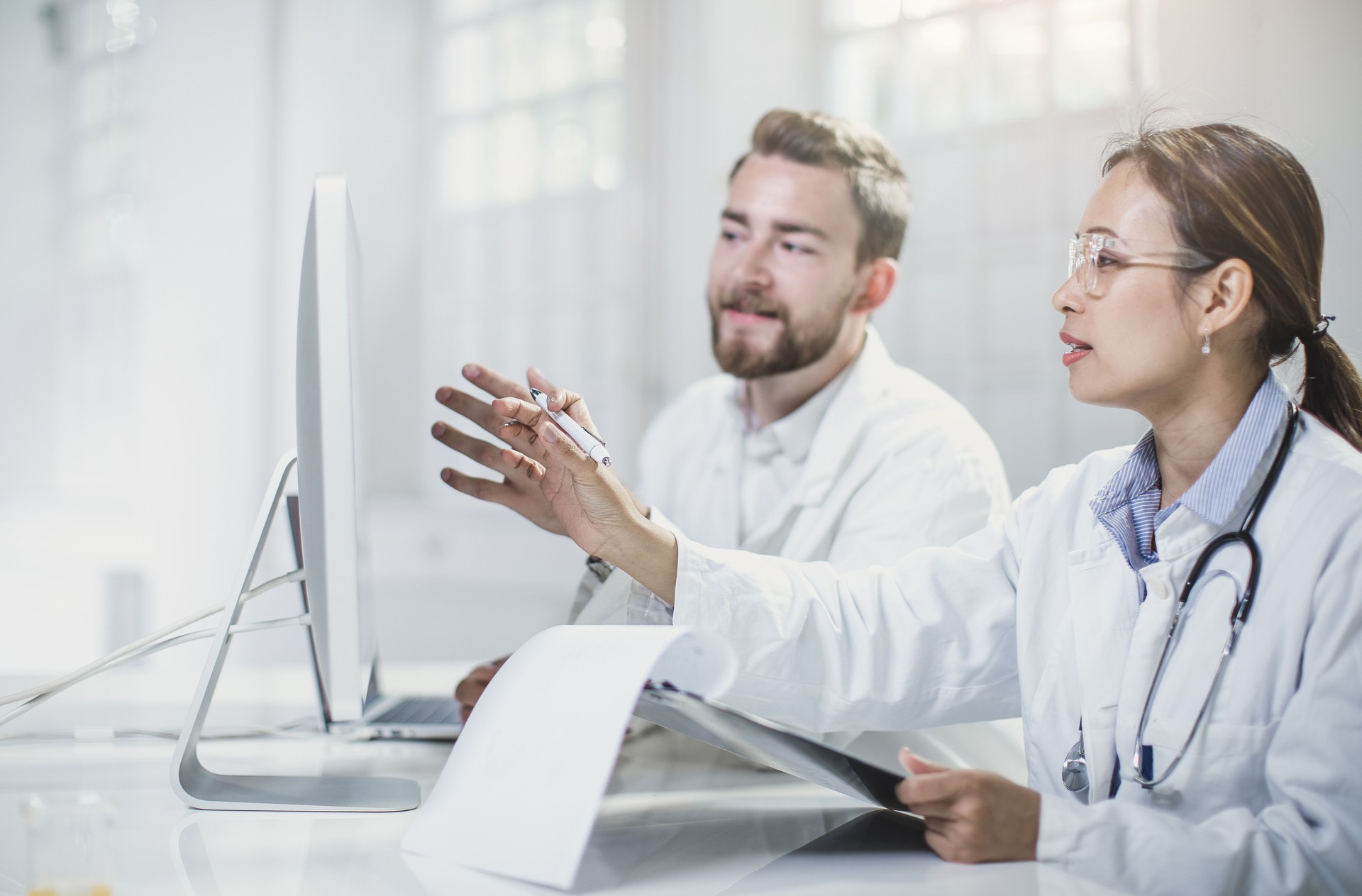 Scientists Looking at Computer Monitor and Discussing